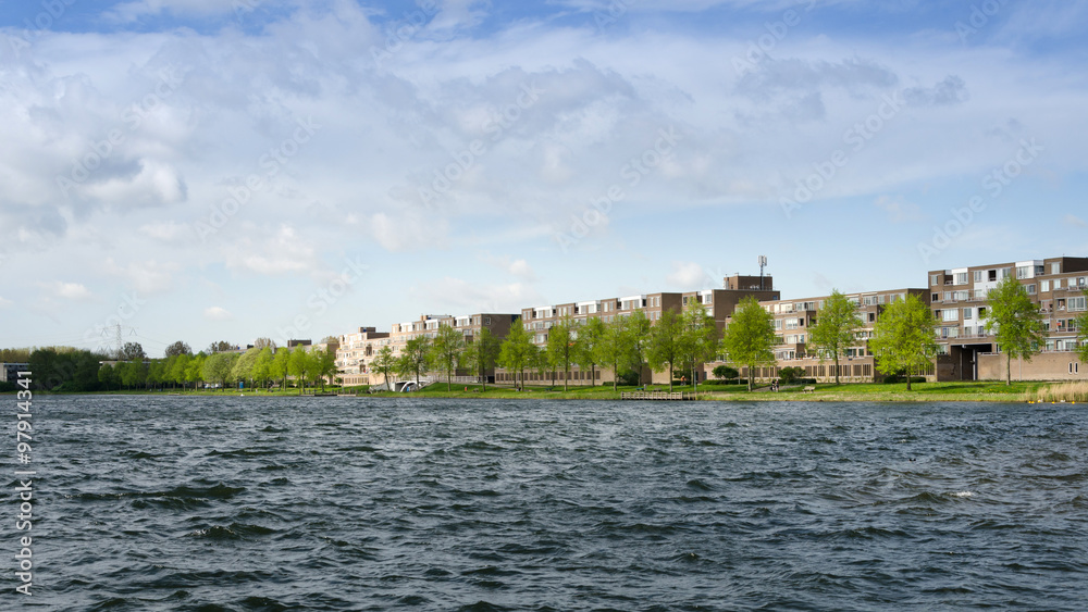 Obraz premium Apartment buildings around Weer water in Almere Stad