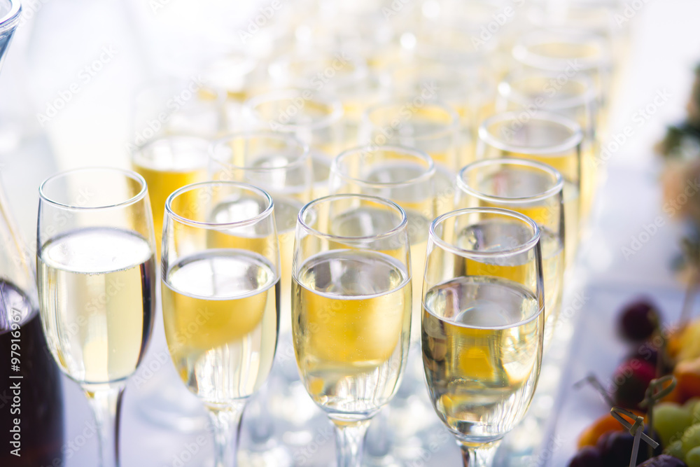 Beautiful row line of different colored alcohol cocktails with mint on a christmas party, martini, vodka with bubbles, wine and others on decorated catering bouquet table on open air event, picture Beautiful row line of different colored alcohol cocktails with mint on a christmas party, martini, vodka with bubbles, wine and others on decorated catering bouquet table on open air event, picture