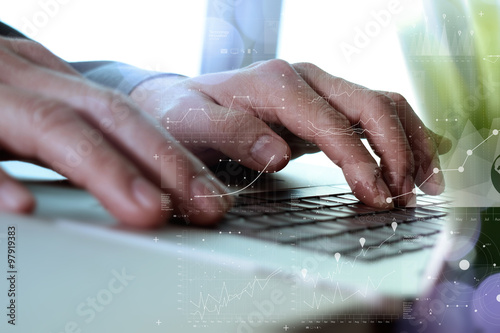 Close up of business man hand working on laptop computer with di