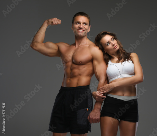  Muscular man and slim woman in sportswear.