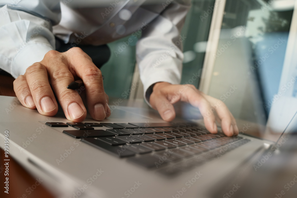 Close up of business man hand working on laptop computer with di Close up of business man hand working on laptop computer with di