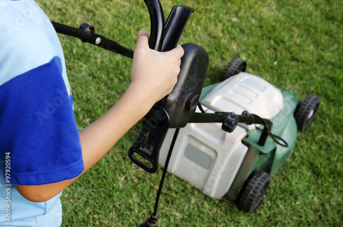 Workers are using a lawn mower in the background. 