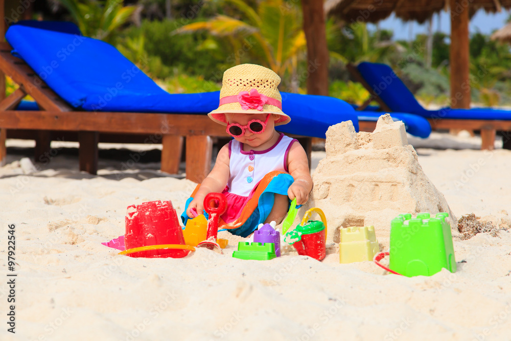 cute little girl playing with sand on beach cute little girl playing with sand on beach