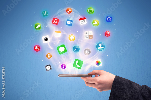 Hand holding tablet phone with app icons