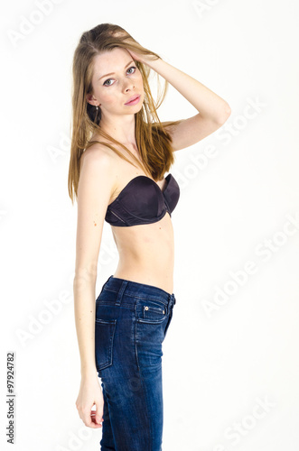 Slim blonde girl in jeans and bra