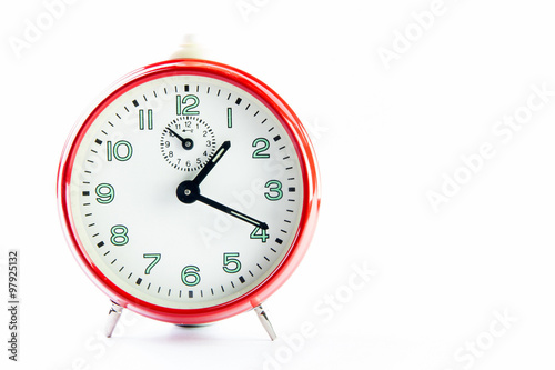 Red alarm clock on the white background.