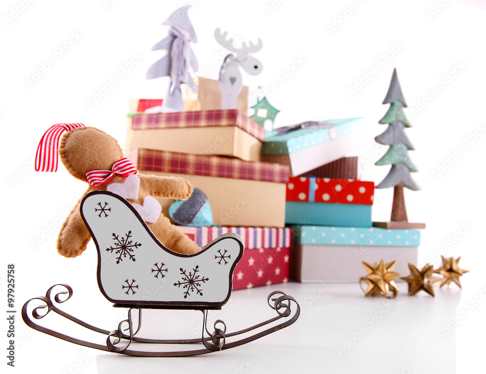 Naklejka premium Sledge on background of beautiful Christmas gifts with toys isolated on white