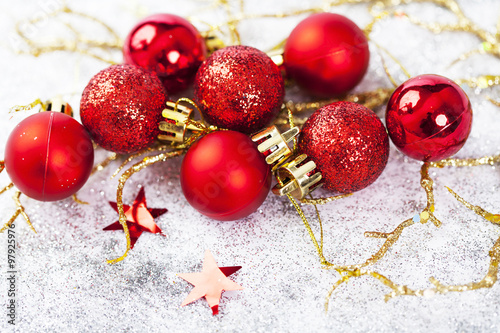 Red Christmas balls on sparkling silver background