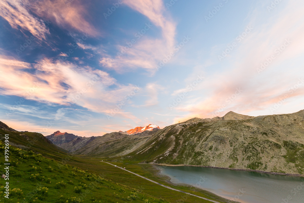 High altitude alpine lake, Gran Paradiso mountain range at sunset
