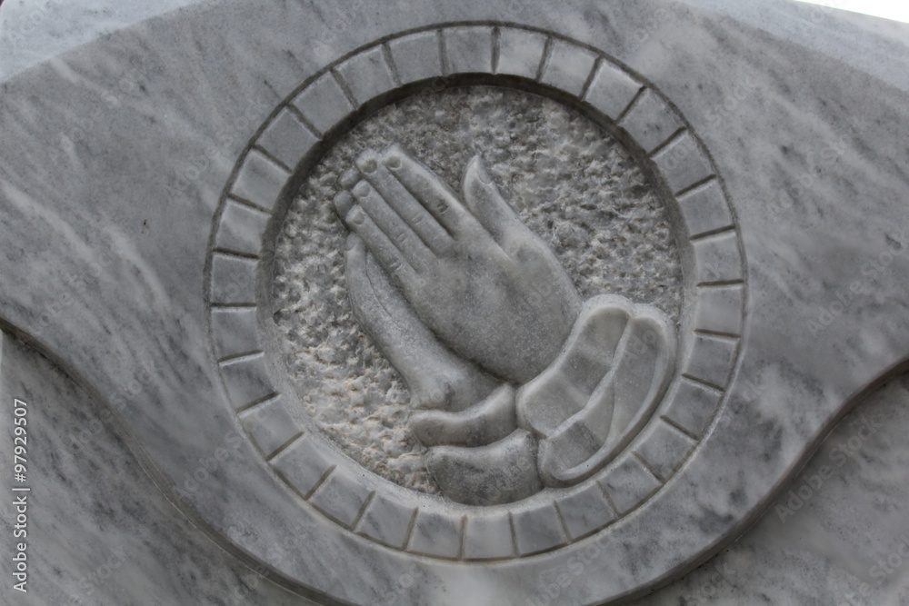 Betende Hände auf einem Grabstein