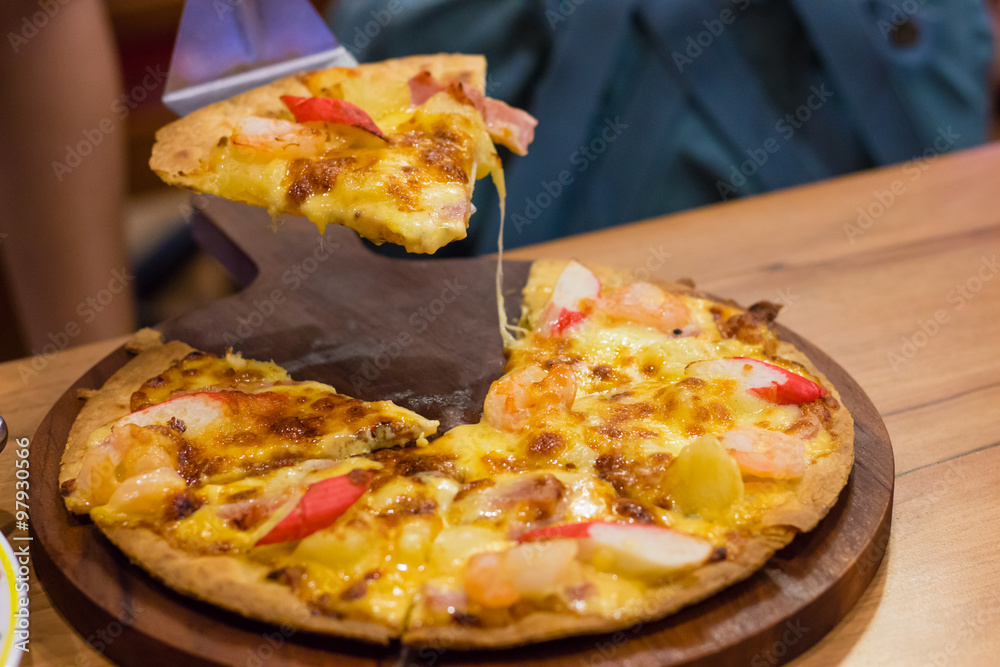 Pizza on circle wooden plate