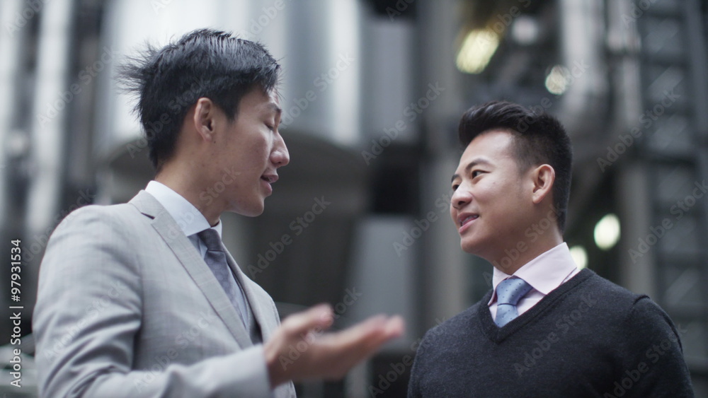  Portrait of smiling Asian businesswoman outdoors in the city with her team
