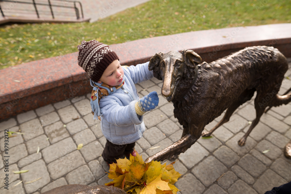 a boy of two years on a walk in a city park