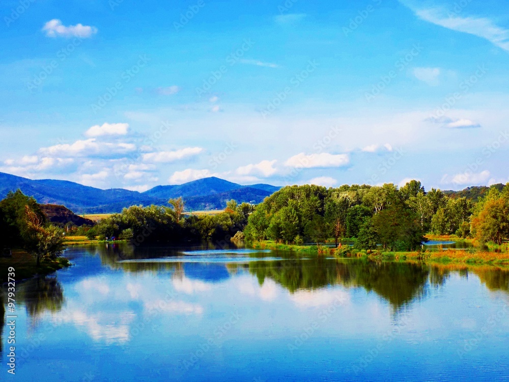 Lake with reflexion, forest and sky