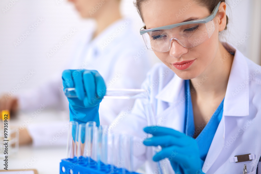 Woman researcher is surrounded by medical vials and flasks, isolated on white background Woman researcher is surrounded by medical vials and flasks, isolated on white background