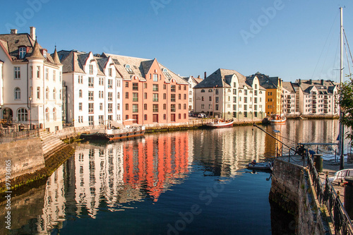 Trondheim, Norway. Multicolored houses in the river bank are ref