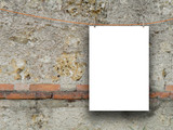 Single paper sheet frame hanged with clothes pin on weathered grey concrete wall background
