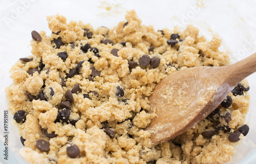 Stirring chocolate chips into cookie dough photo