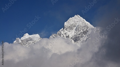 Peak of Mt Thamserku surrounded by clouds