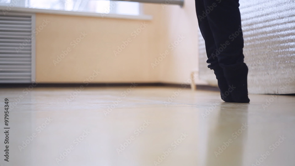 young girl doing a work-out in the dance hall. making stretching exercise, feet closeup young girl doing a work-out in the dance hall. making stretching exercise, feet closeup