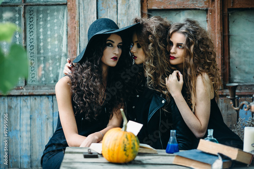 three vintage witch sitting at the table