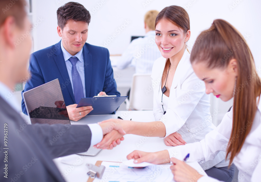 Business people shaking hands, finishing up a meeting Business people shaking hands, finishing up a meeting
