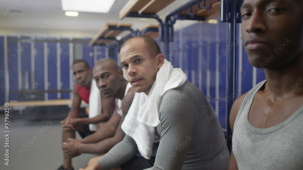 Portrait of serious sports players in team locker room Portrait of serious sports players in team locker room