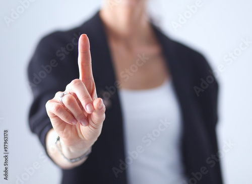 Woman touching an imaginary screen with her finger - isolated