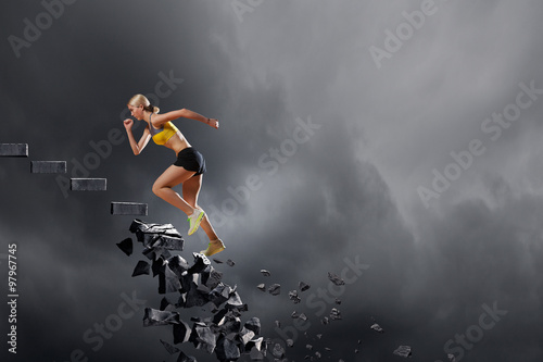 Sports woman overcoming challenges © Sergey Nivens