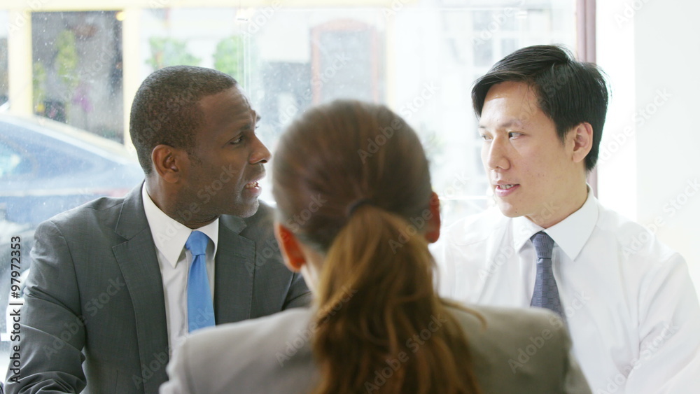 Concerned businessmen interviewing a colleague Concerned businessmen interviewing a colleague