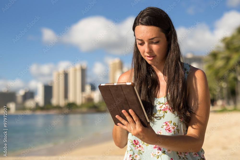 Young woman in Hawaii using tablet computer