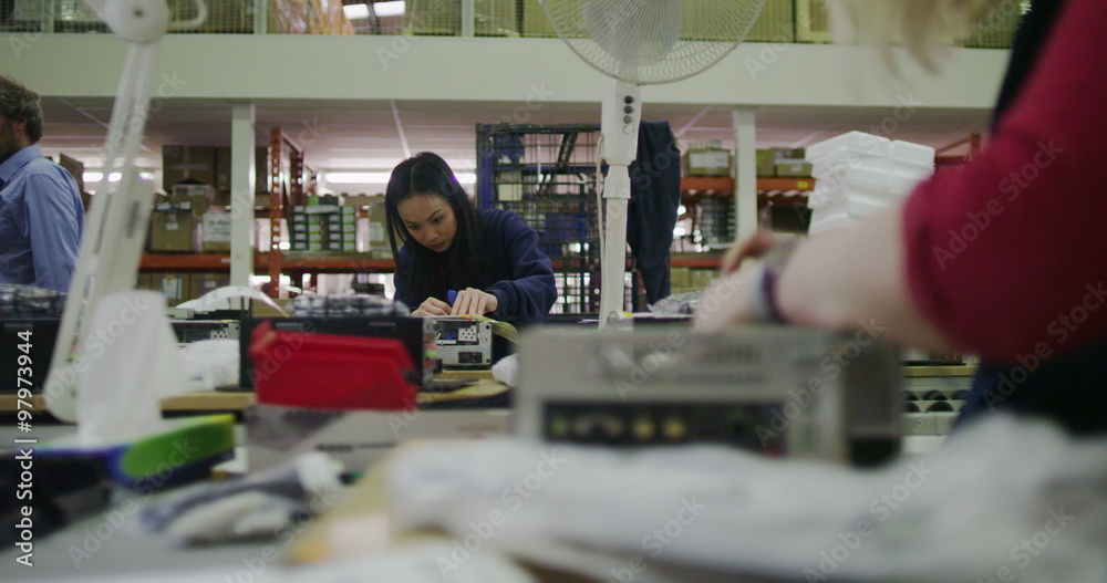 Workers building computers in a British electronics factory Workers building computers in a British electronics factory