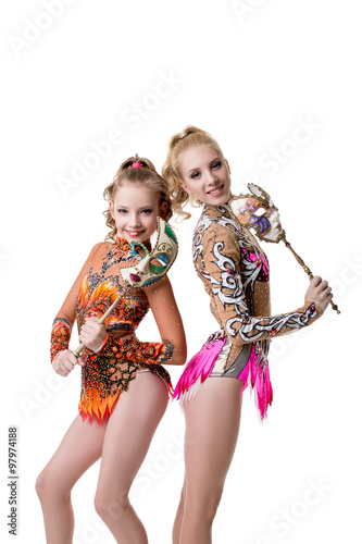 Pretty young gymnasts posing with carnival masks