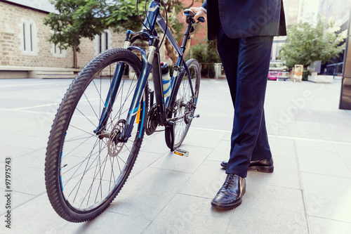 Successful businessman riding bicycle