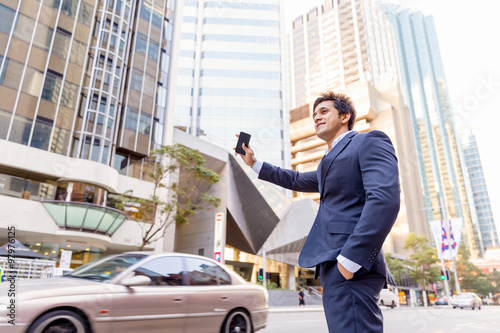 Businessman catching taxi in city