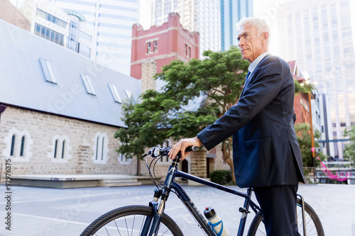 Successful businessman riding bicycle