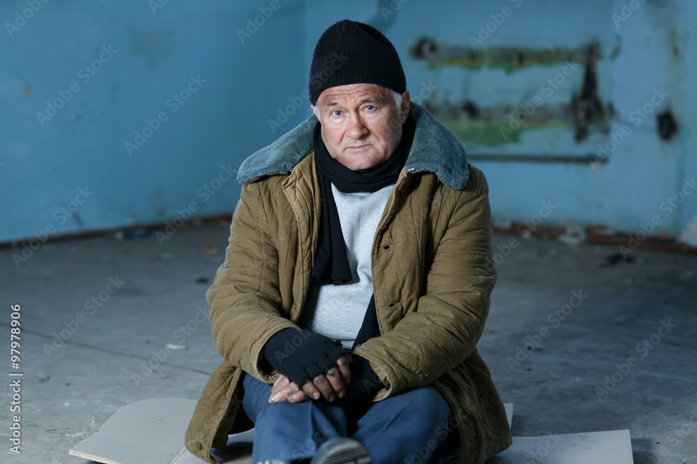 Homeless person sitting on the floor. 