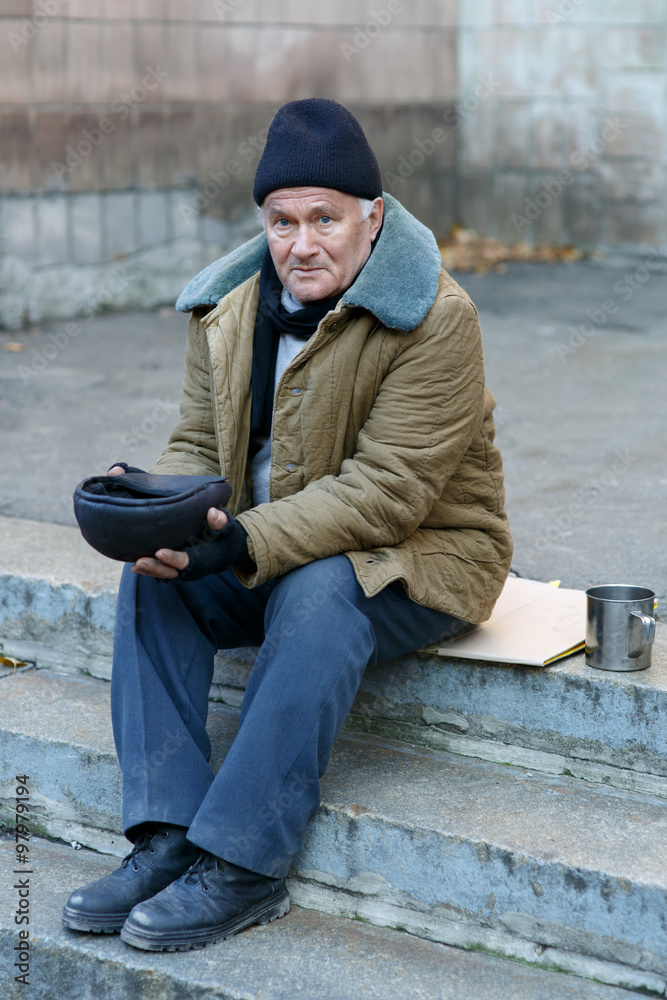 Homeless man holding his cap. Homeless man holding his cap.