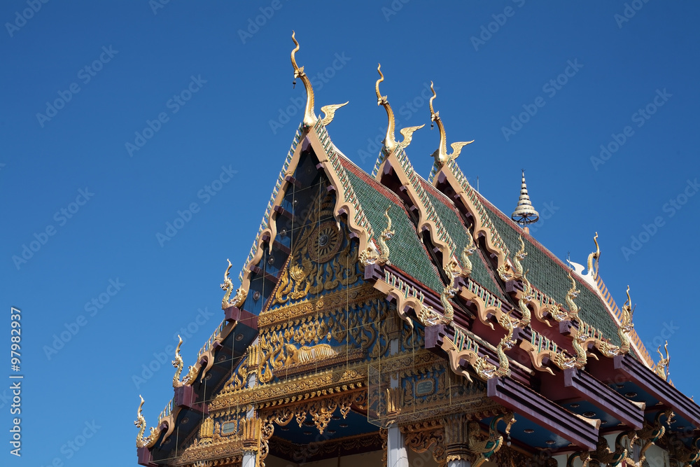 thai temple against blue sky.