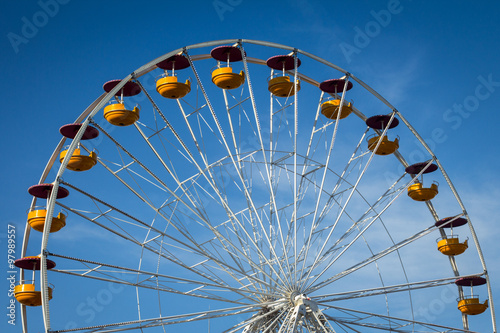 Ferris wheel over blue sky