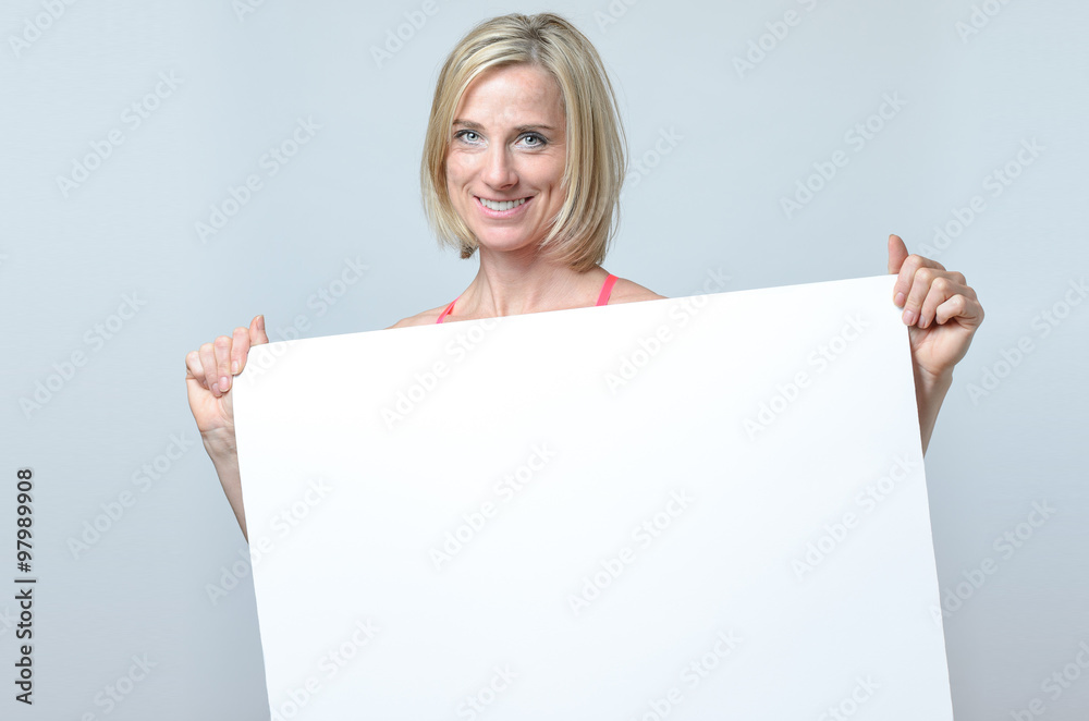 Attractive blond woman holding a blank sign Attractive blond woman holding a blank sign