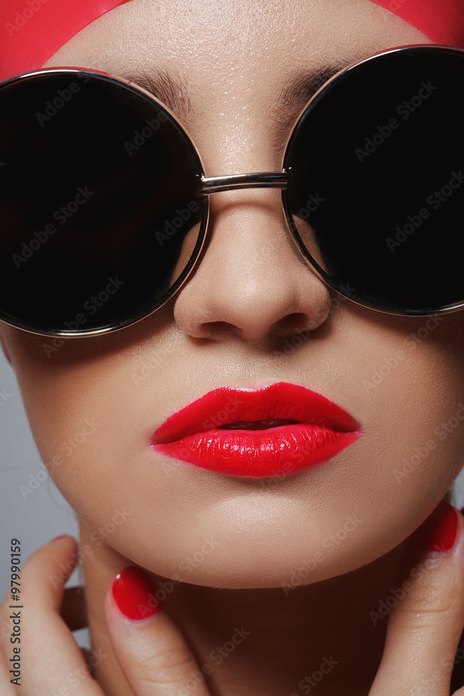 Beautiful face with glasses closeup. Sexy model with red lipstick and manicure. Beautiful face with glasses closeup. Sexy model with red lipstick and manicure.