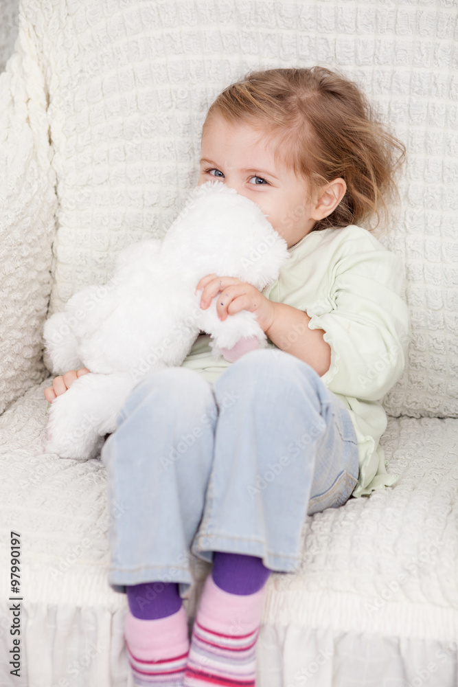 Cheerful female child is playing with fluffy toy Cheerful female child is playing with fluffy toy