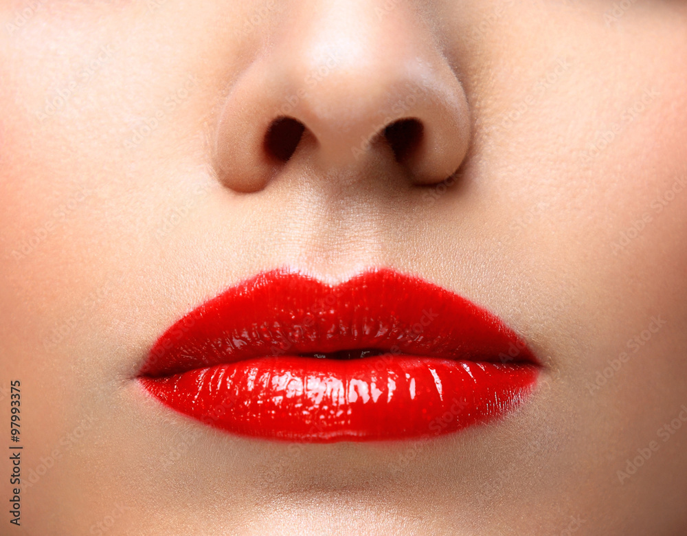 Obraz premium Red Sexy Lips and Nails closeup. Open Mouth. Manicure and Makeup. Make up concept. Half of Beauty model girl's face isolated on black background