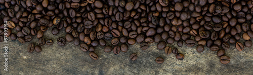 Coffee beans on wood texture background