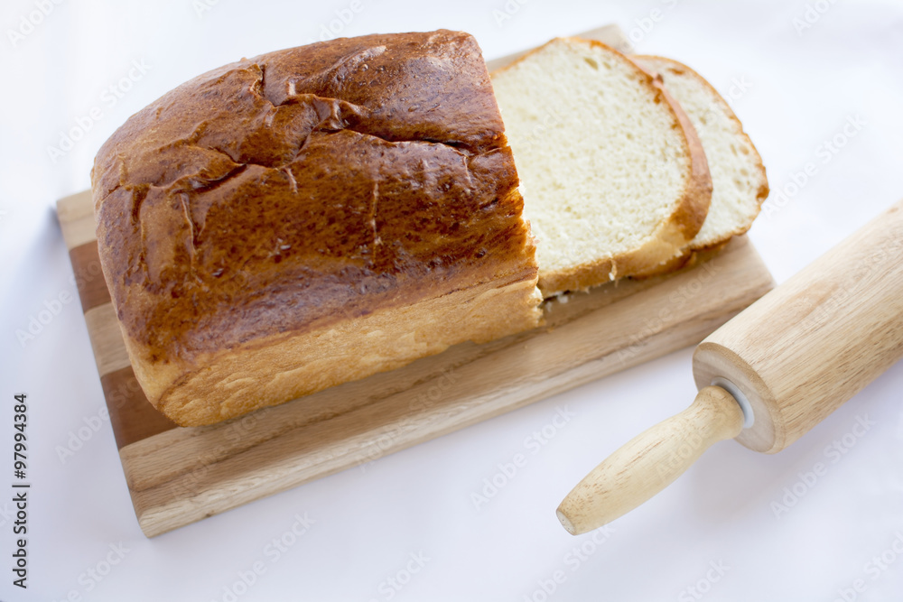 Delicious homemade white bread on wood cutting board selected fo