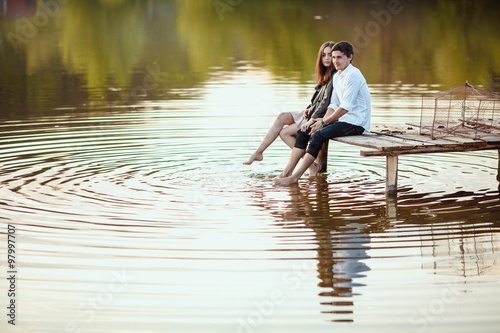 Couple on the wooden jetty at a lake