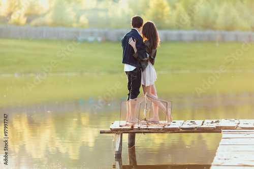 Couple on the wooden jetty at a lake