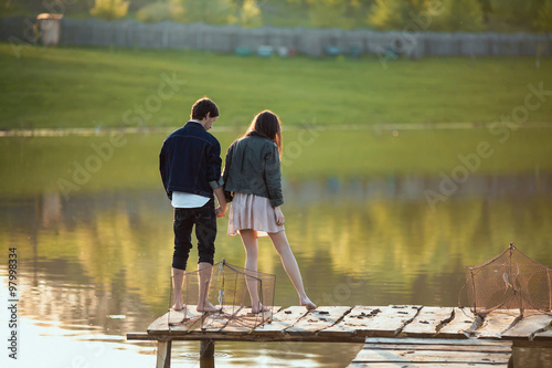 Couple on the wooden jetty at a lake