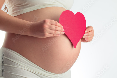 Wallpaper Mural Abdomen of pregnant woman and red heart on white Torontodigital.ca